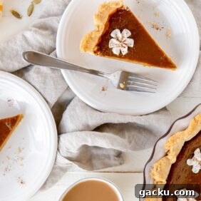 Homemade Pumpkin Pie Recipe: Classic Scratch-Baked Pie 12 slices of pumpkin pie on round white plates with forks