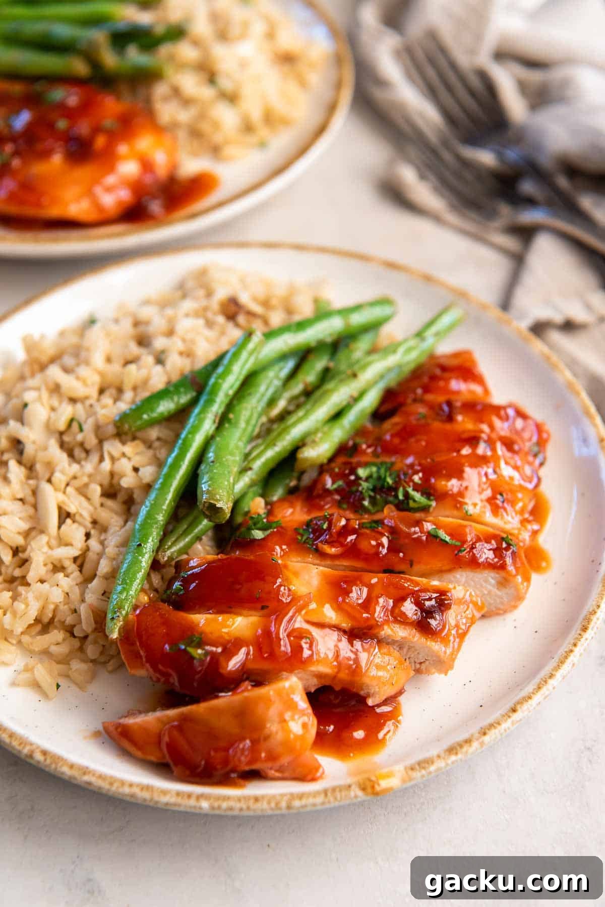 Catalina chicken on a dinner plate with rice and green beans.