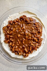 Top down view of no bake pecan pie dip in round glass dish.