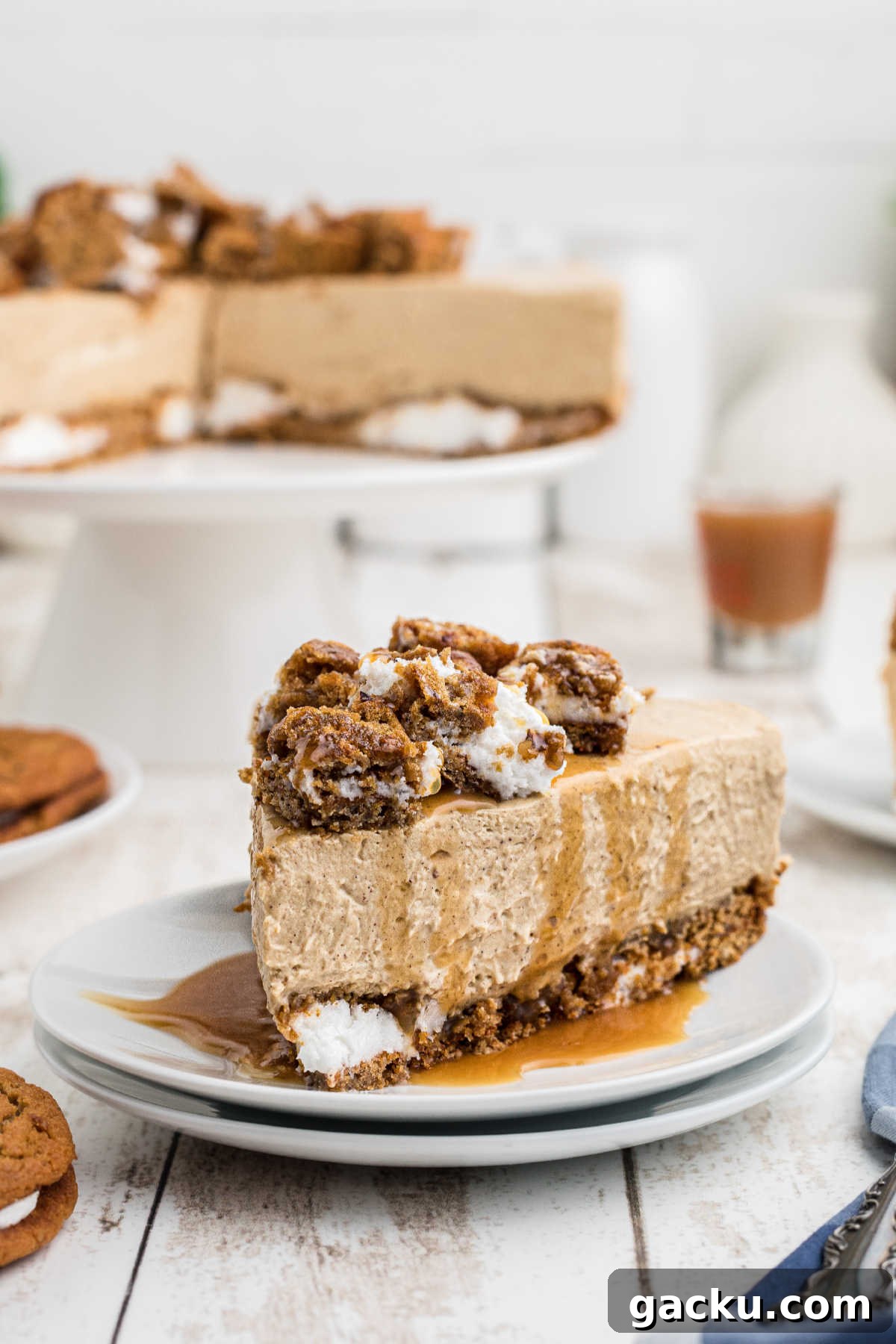A piece of oatmeal creme pie cheesecake drizzled with caramel sauce.