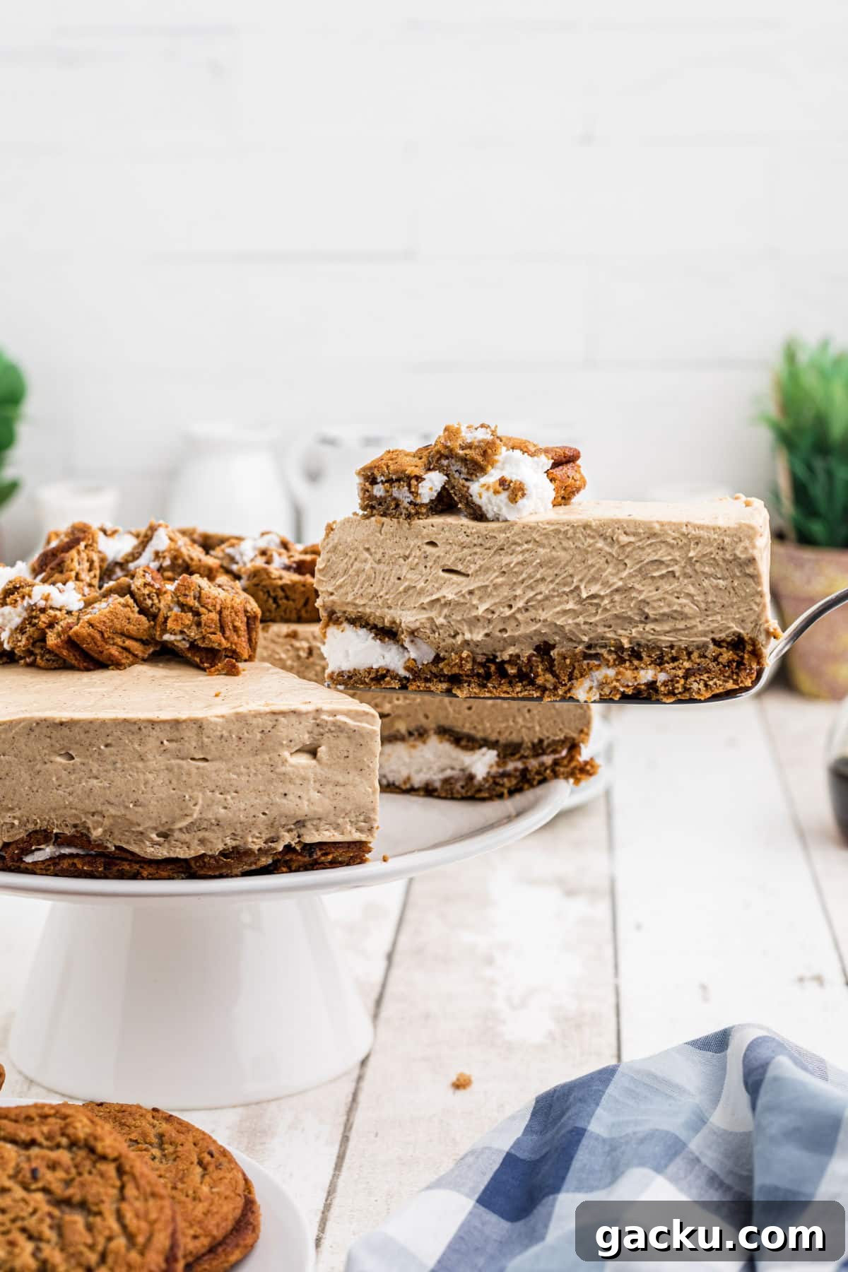 A slice of oatmeal creme pie cheesecake being lifted out of the whole thing.