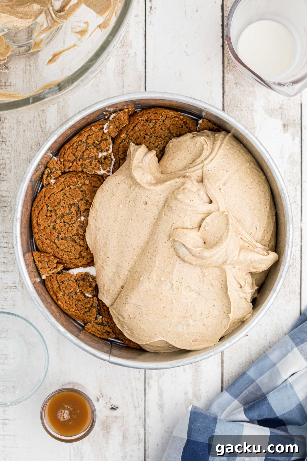 A cream cheese mixture being poured onto an oatmeal creme pie base.