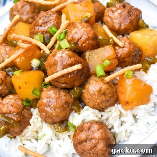 crockpot hawaiian meatballs over steamed white rice on a white dinner plate