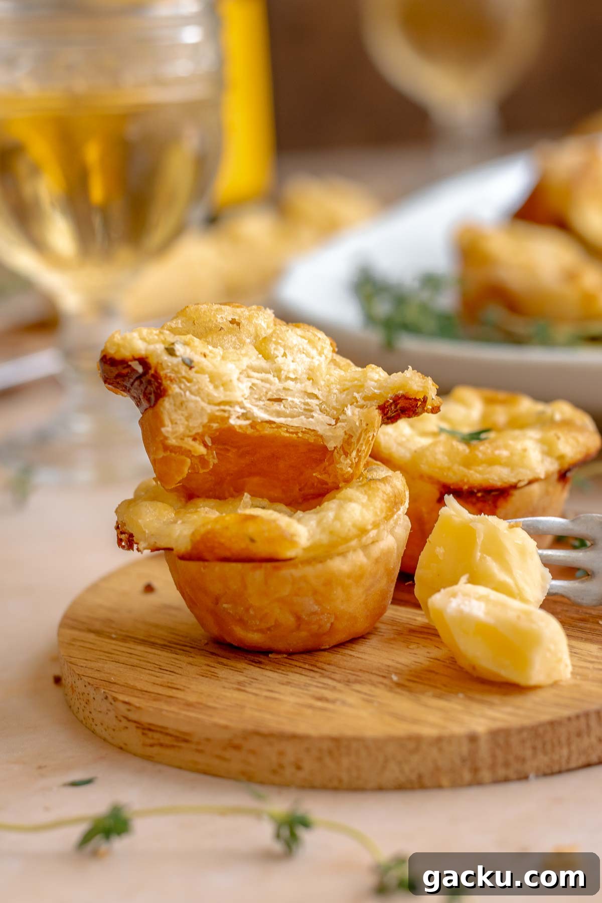 Mini Cheese Tartlets Recipe: Crispy Crusts with Creamy Filling 2 A stack of cheese puffs on a wooden board.