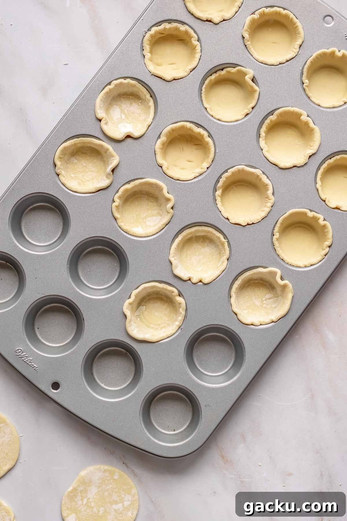 Mini Cheese Tartlets Recipe: Crispy Crusts with Creamy Filling 8 Puff pastry rounds pressed into a mini muffin tin.