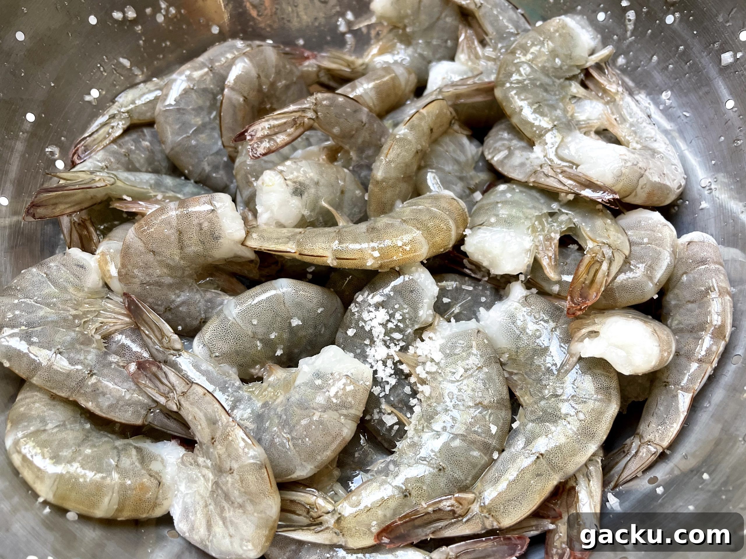 raw shrimp sprinkled with coarse salt. raw shrimp sprinkled with coarse salt.