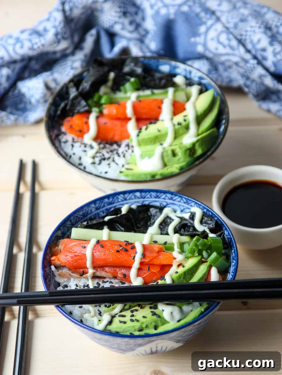 Salmon Chirashi Sushi Bowl Recipe: Easy Homemade Salmon Donburi 4 Two salmon sushi bowls with chopsticks.