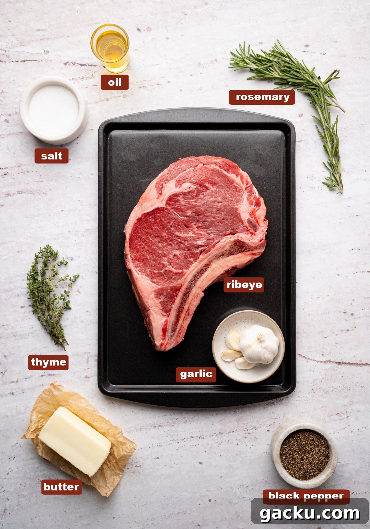All of the ingredients for ribeye steak in bowls or a dish on a countertop.