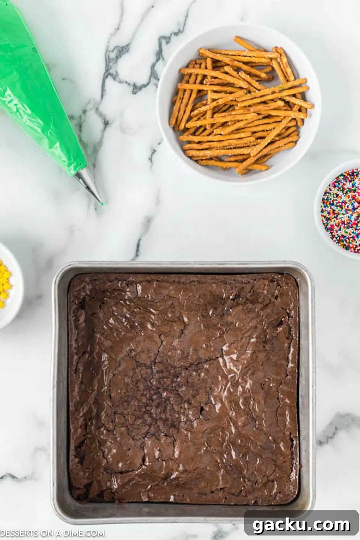 Christmas Tree Brownie Recipe: Festive Layered Chocolate Treat 3 Ingredients for Christmas Tree Brownies - brownies, icing, sprinkles, pretzel sticks.