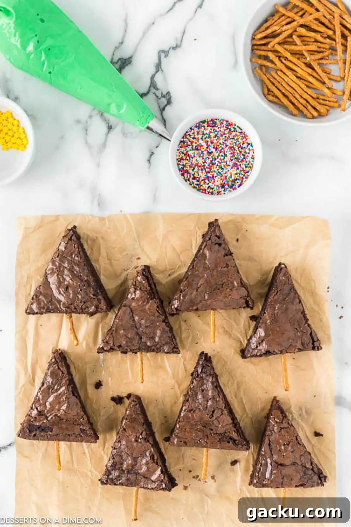 Christmas Tree Brownie Recipe: Festive Layered Chocolate Treat 4 Brownies cut into triangles on a wooden board.