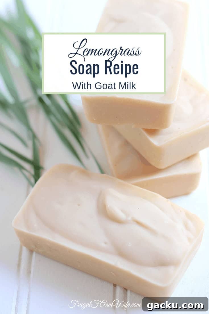 Photo shows several bars of off white lemongrass goat milk soap stacked on a white shiplap board. Text overlay reads "Lemongrass Soap Recipe with Goat Milk"