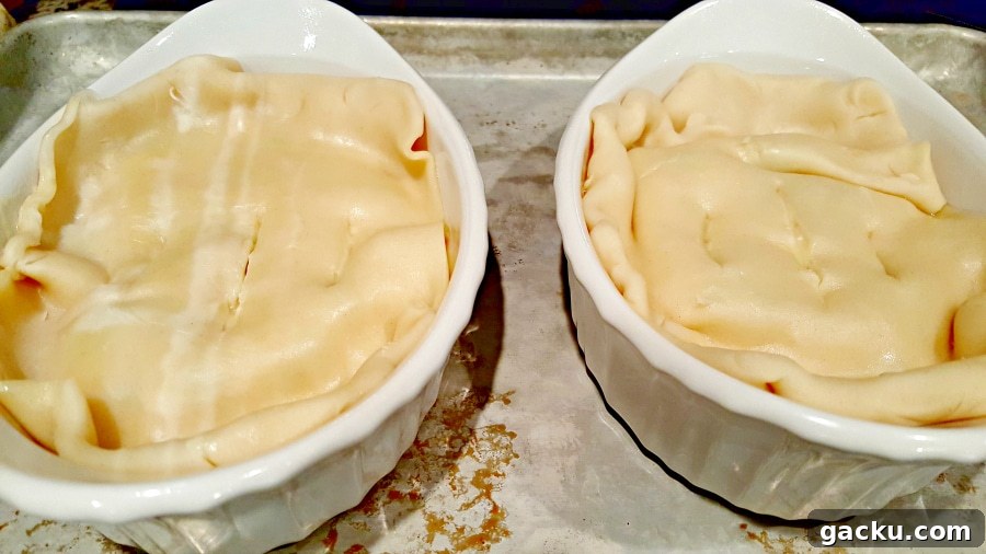 Ultimate Creamy Chicken Pot Pie Recipe for Comforting Weeknight Meals 6 Individual Chicken Pot Pies topped with pie crust.