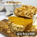Sliced mini pumpkin loaves on a wooden board.