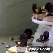 Oreo mousse cups placed on a white plate with a golden spoon on the side