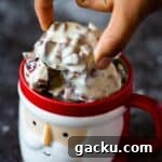 close up image of picking up a cluster from a mug full of cranberry clusters