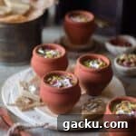close up image of kaju katli kulfi in matkas
