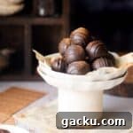 cropped image of coffee truffles placed on a plate