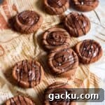close up image of chocolate condensed milk cookies placed on brown paper
