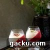two glasses filled with kheer and jelly placed on a plate