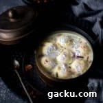 cropped up image of rasgulla rasmalai placed in the tiffin box