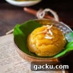 close up image of scooped out badam halwa on a banana leaf