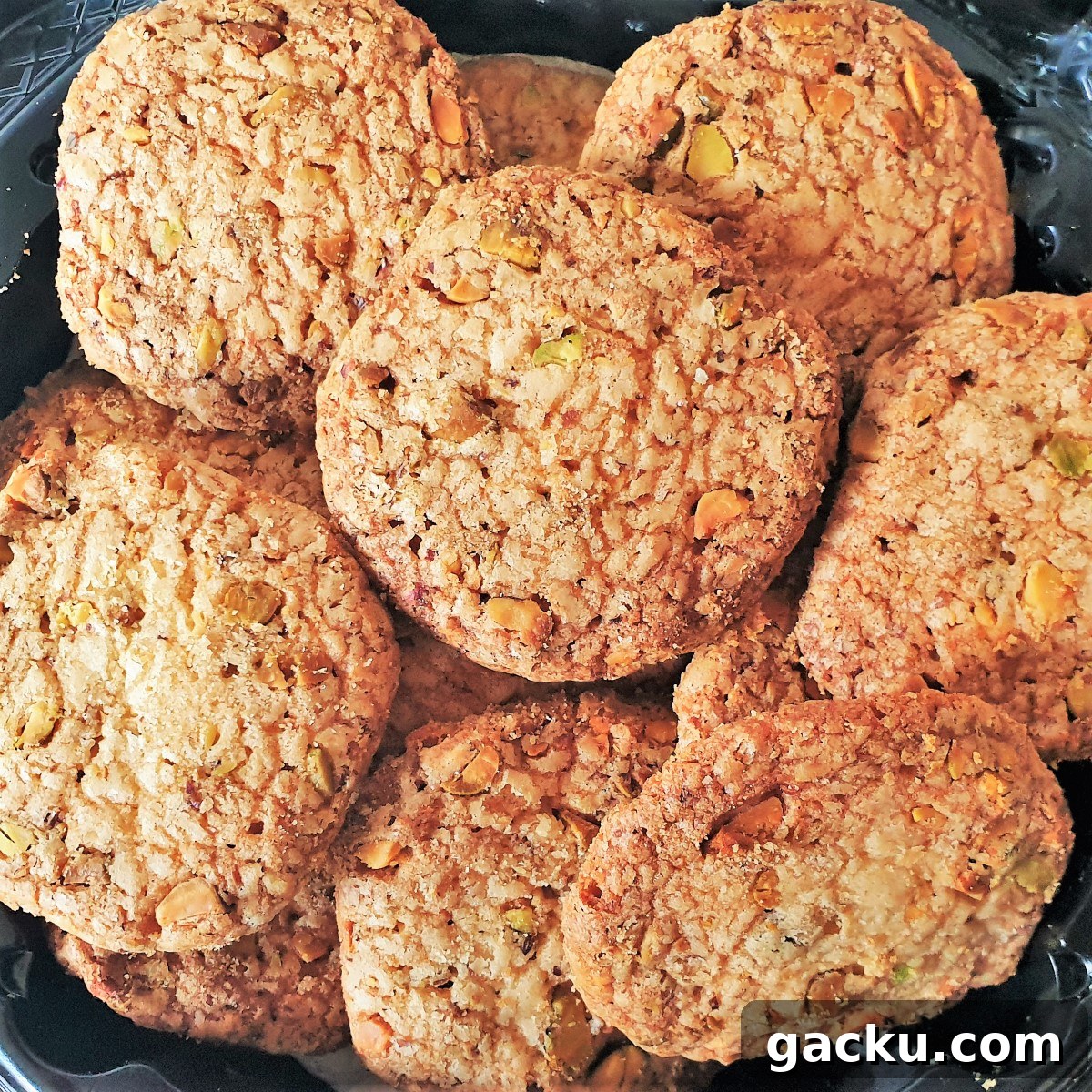 Crispy Pistachio Butter Biscuits with Extra Crunch 3 A heap of baked pistachio butter biscuits on a plate.