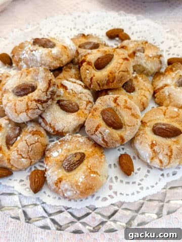 A glass plate with a pile of lemon amaretti biscuits.