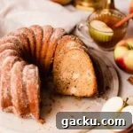 apple cider bundt cake sliced on a cake plate
