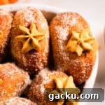pumpkin donuts with piped filling peaking out in casserole dish