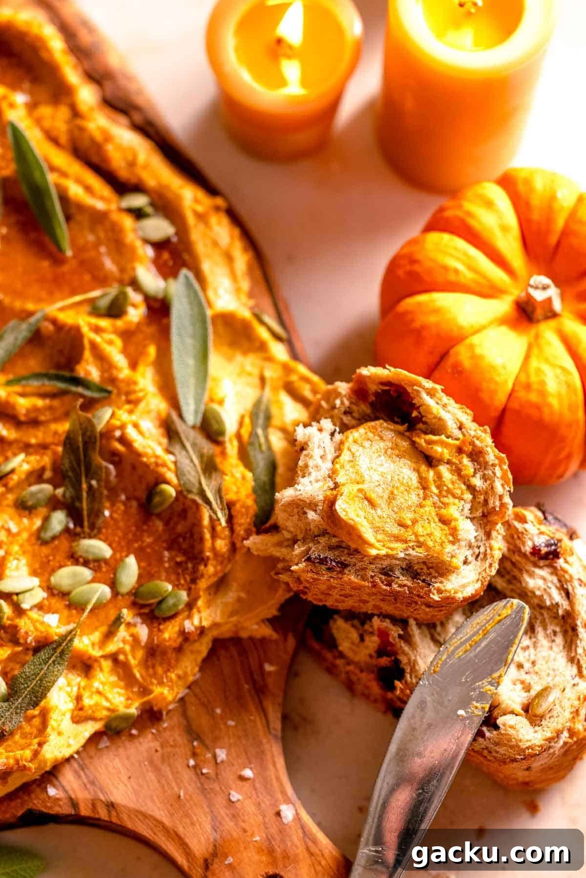 pumpkin butter spread on cranberry seeded bread with mini pumpkins and candles