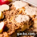 glaze dripping off apple cinnamon roll