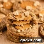 stack of pumpkin cheesecake filled cookies on parchment paper