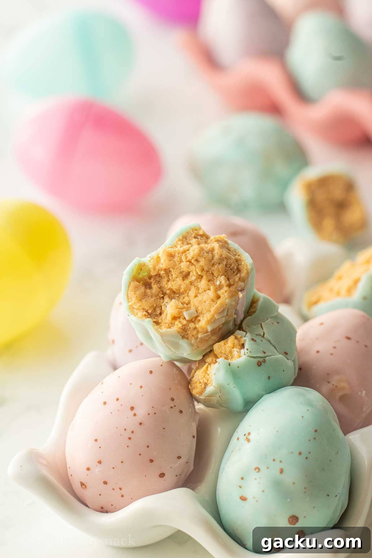 Half of a chocolate dipped peanut butter easter egg in egg carton.