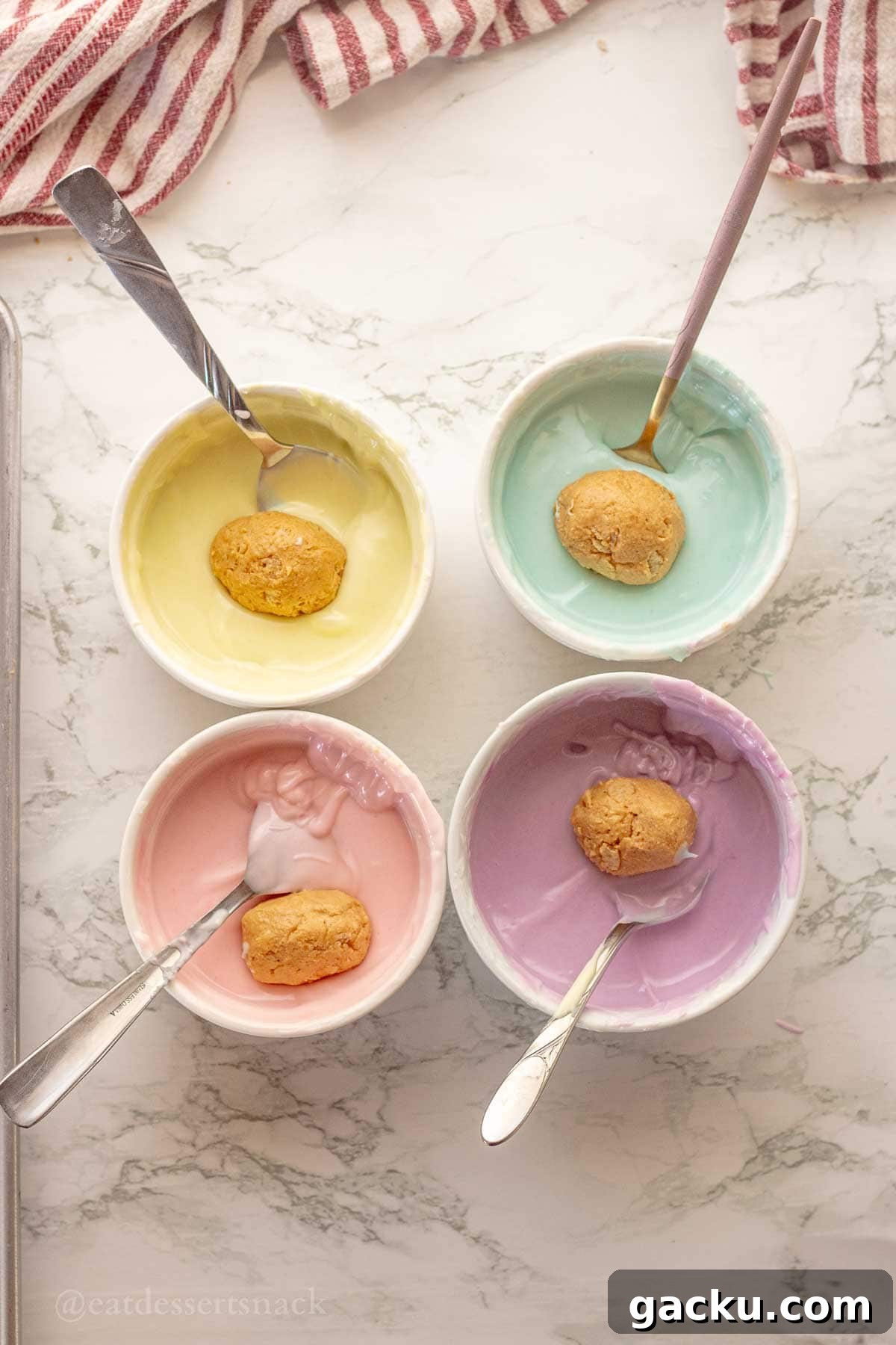 Dipping eggs in colored chocolate with forks.