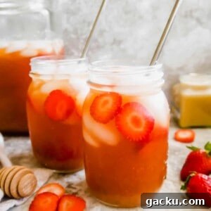 Refreshing Strawberry Iced Tea Recipe: Cool Summer Drink 11 Strawberry Sweet Tea in mason jars with straws in them.