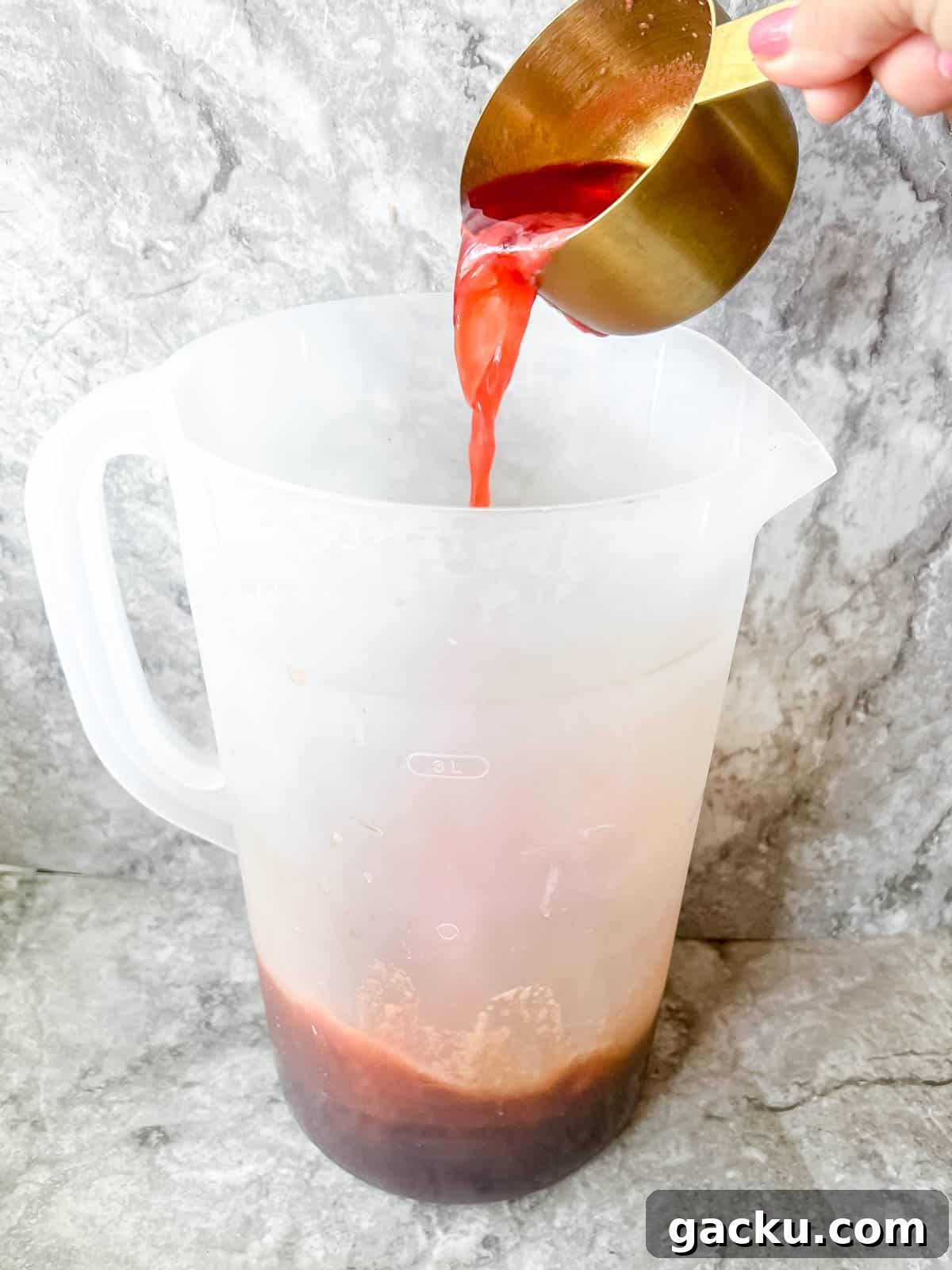 Refreshing Strawberry Iced Tea Recipe: Cool Summer Drink 7 Adding strawberry juice to iced tea.