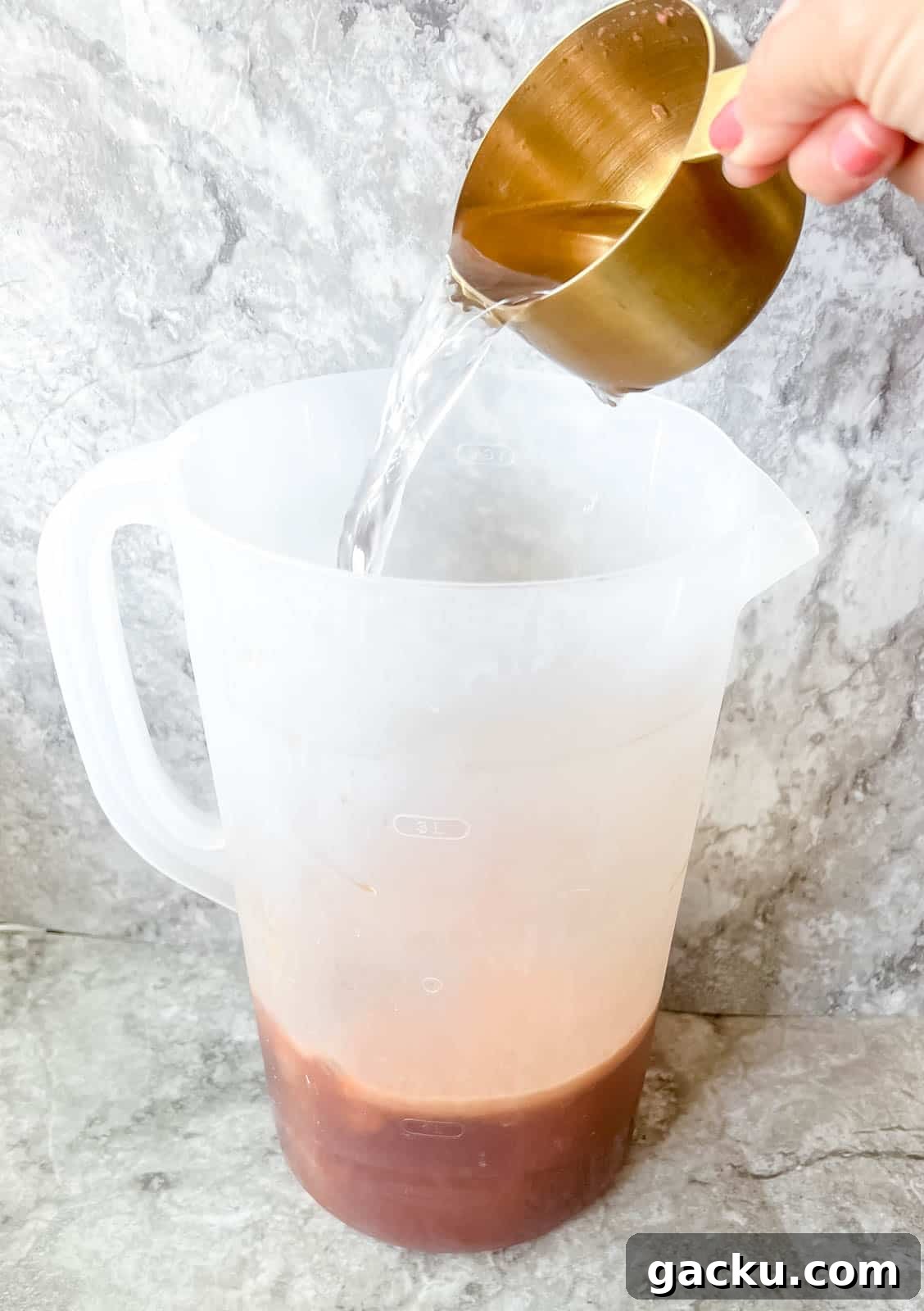 Refreshing Strawberry Iced Tea Recipe: Cool Summer Drink 8 Adding water to strawberry sweet tea.
