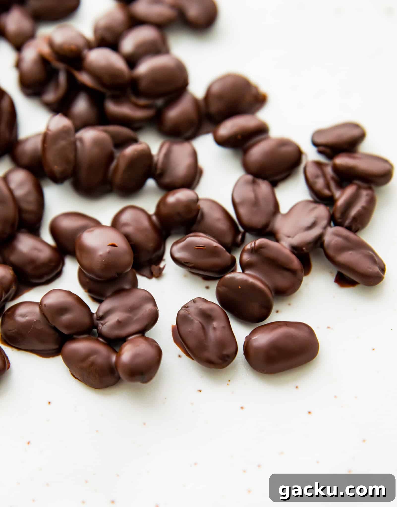 A plate full of chocolate covered coffee beans.