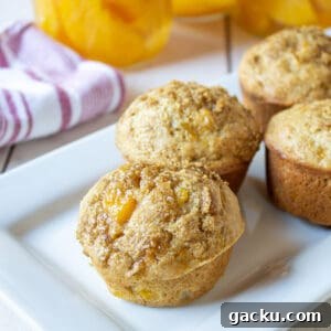 Juicy Peach Muffin Recipe for Perfect Summer Breakfast 16 A platter filled with peach muffins.