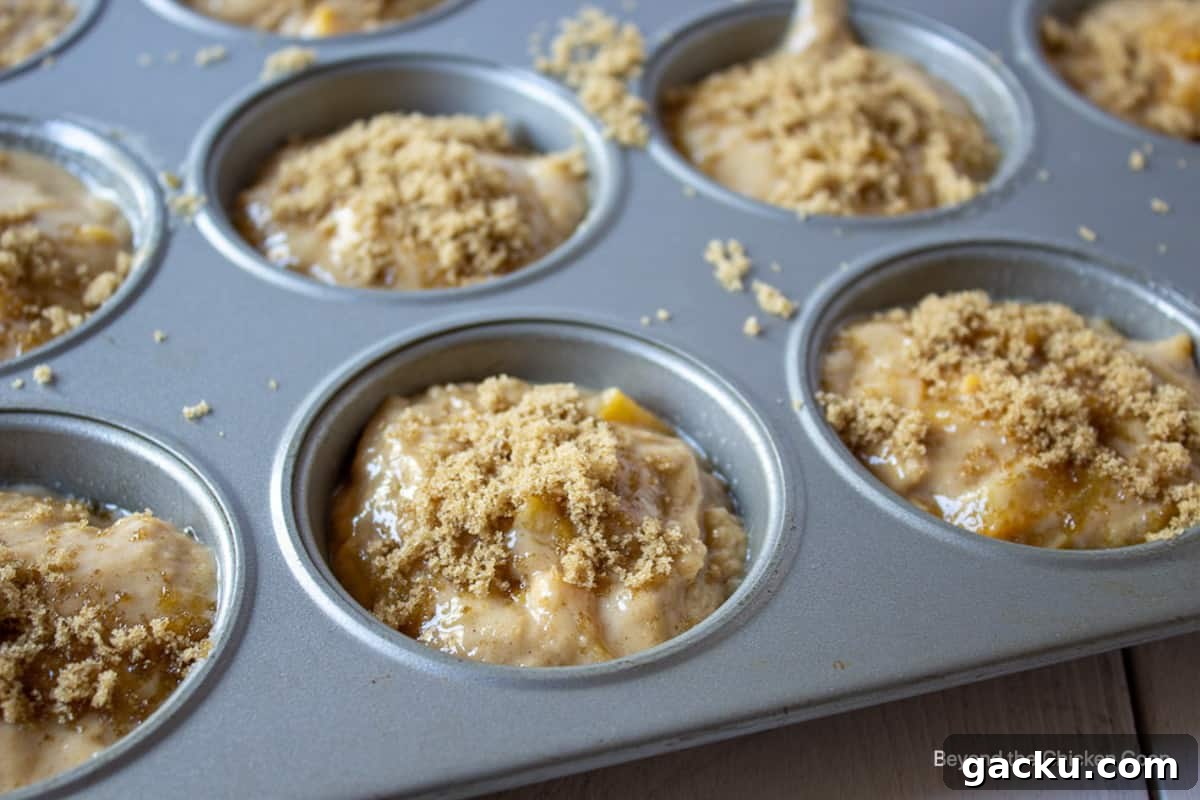 Juicy Peach Muffin Recipe for Perfect Summer Breakfast 10 A muffin tin filled with muffin batter.