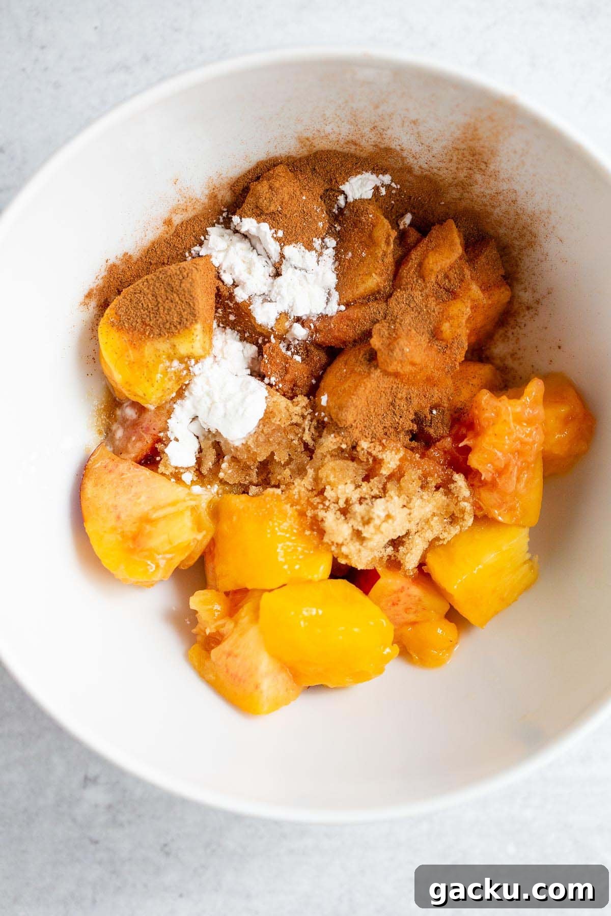 Peaches, brown sugar, cinnamon, in a bowl.