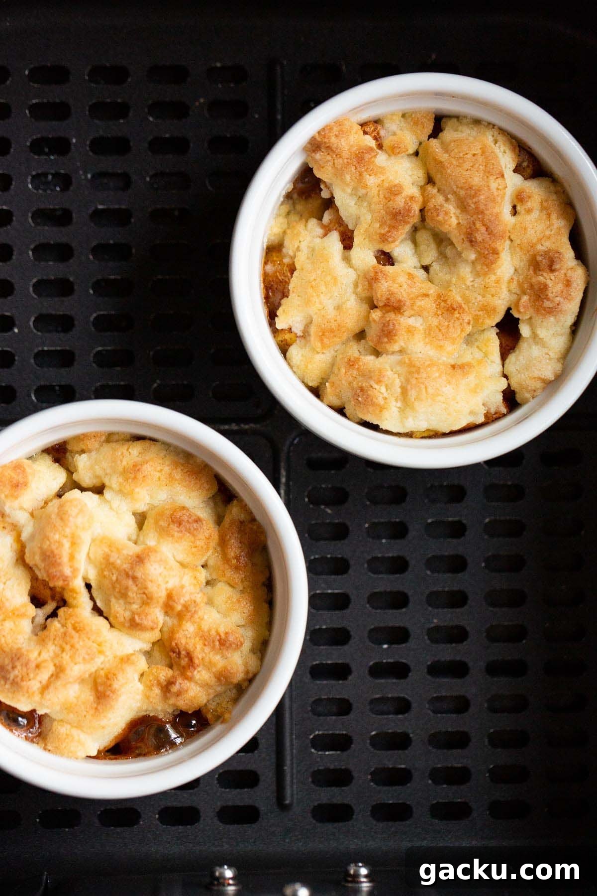 Cooked peach cobbler in air fryer basket.