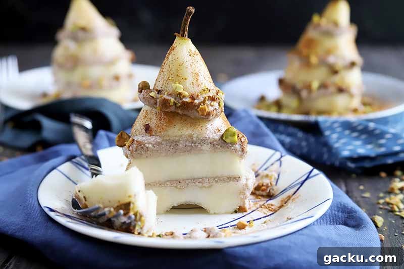 Horizontal image of a whole pear sliced and layered with a cinnamon filling next to a piece of the dessert on a fork, in front of two identically plated desserts in the background.
