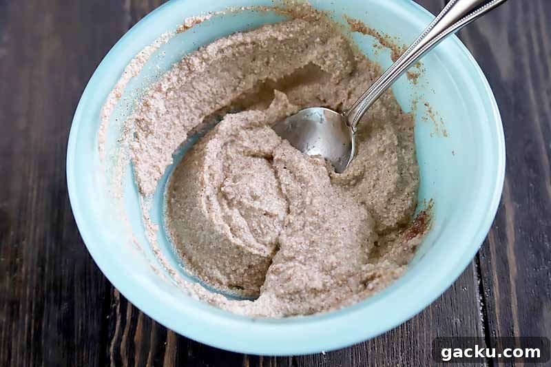 Horizontal image of a blue plate with a cinnamon and ricotta mixture.
