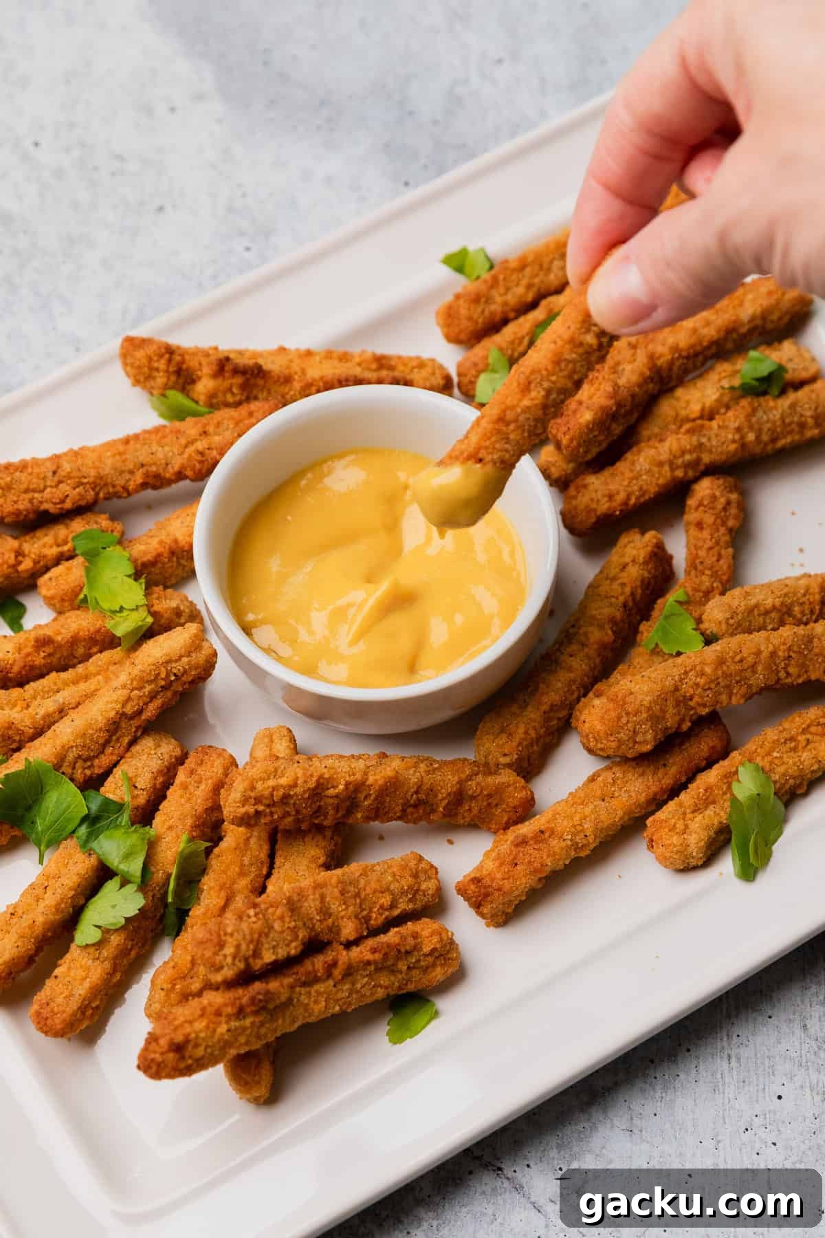 dipping chicken fries into honey mustard.