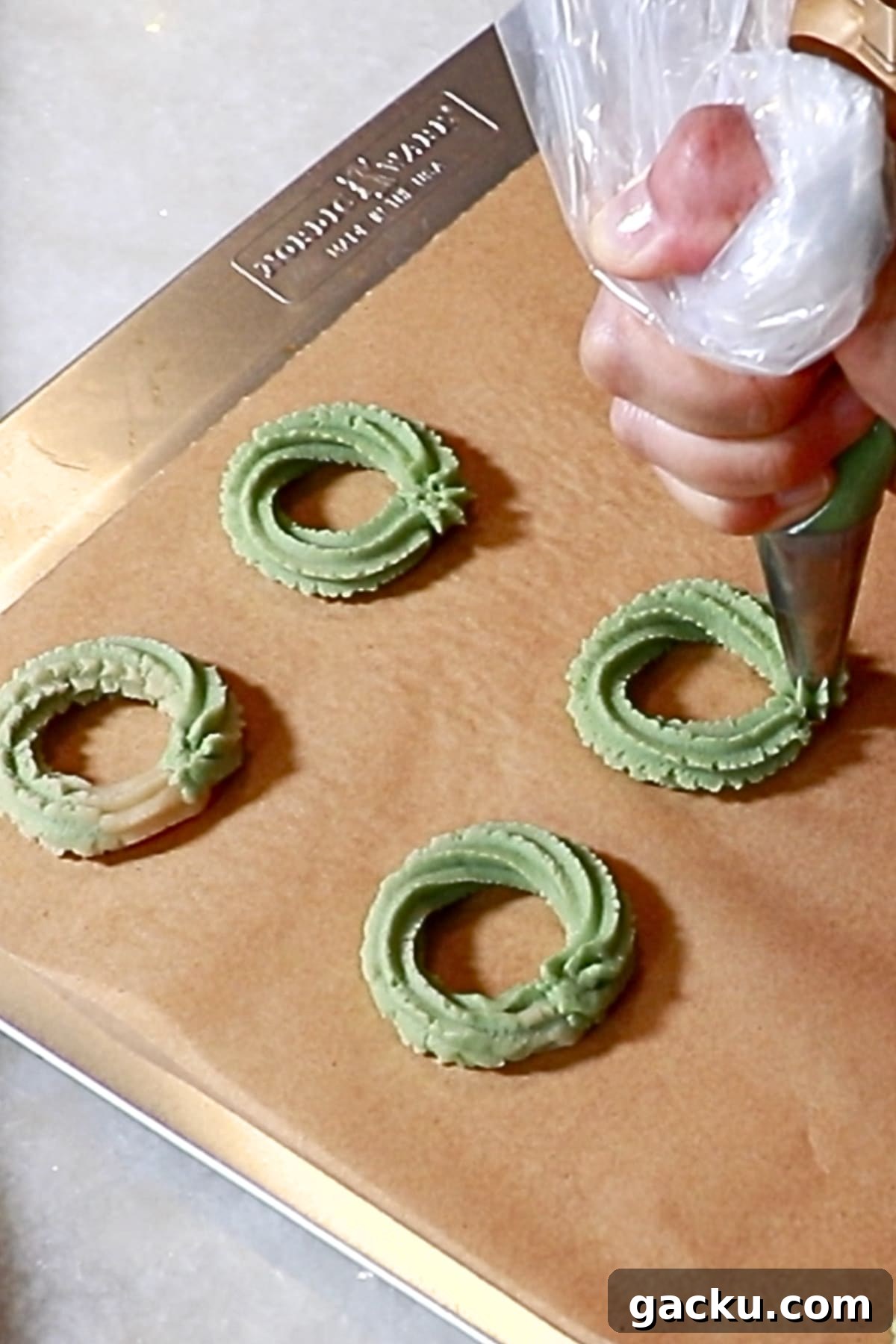 piping circles with green cookie dough
