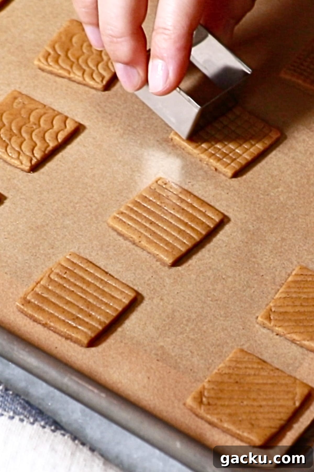adding patterns on top of square cookie dough