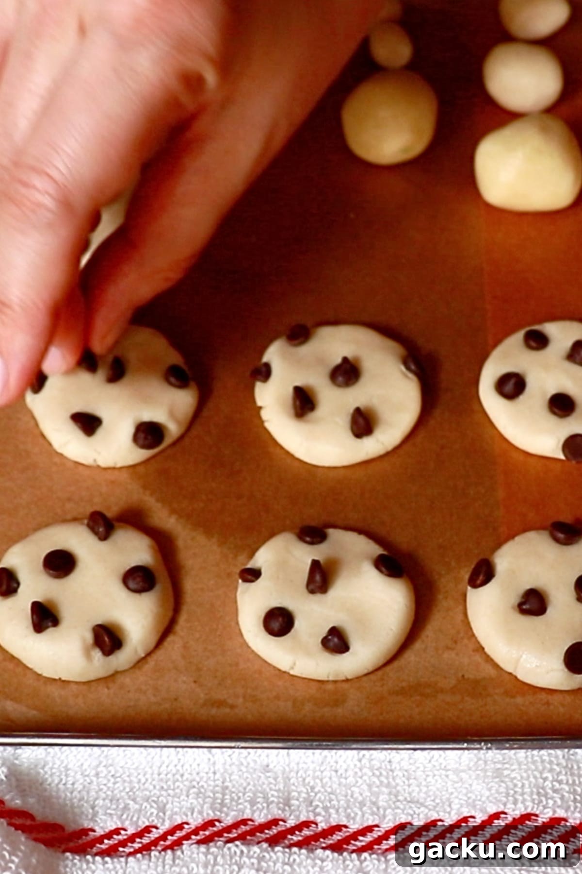 attaching mini chocolate chips on cookie dough