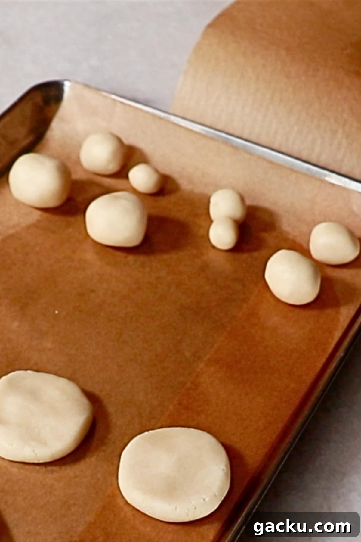 forming balls with a cookie dough to make snowball cookies