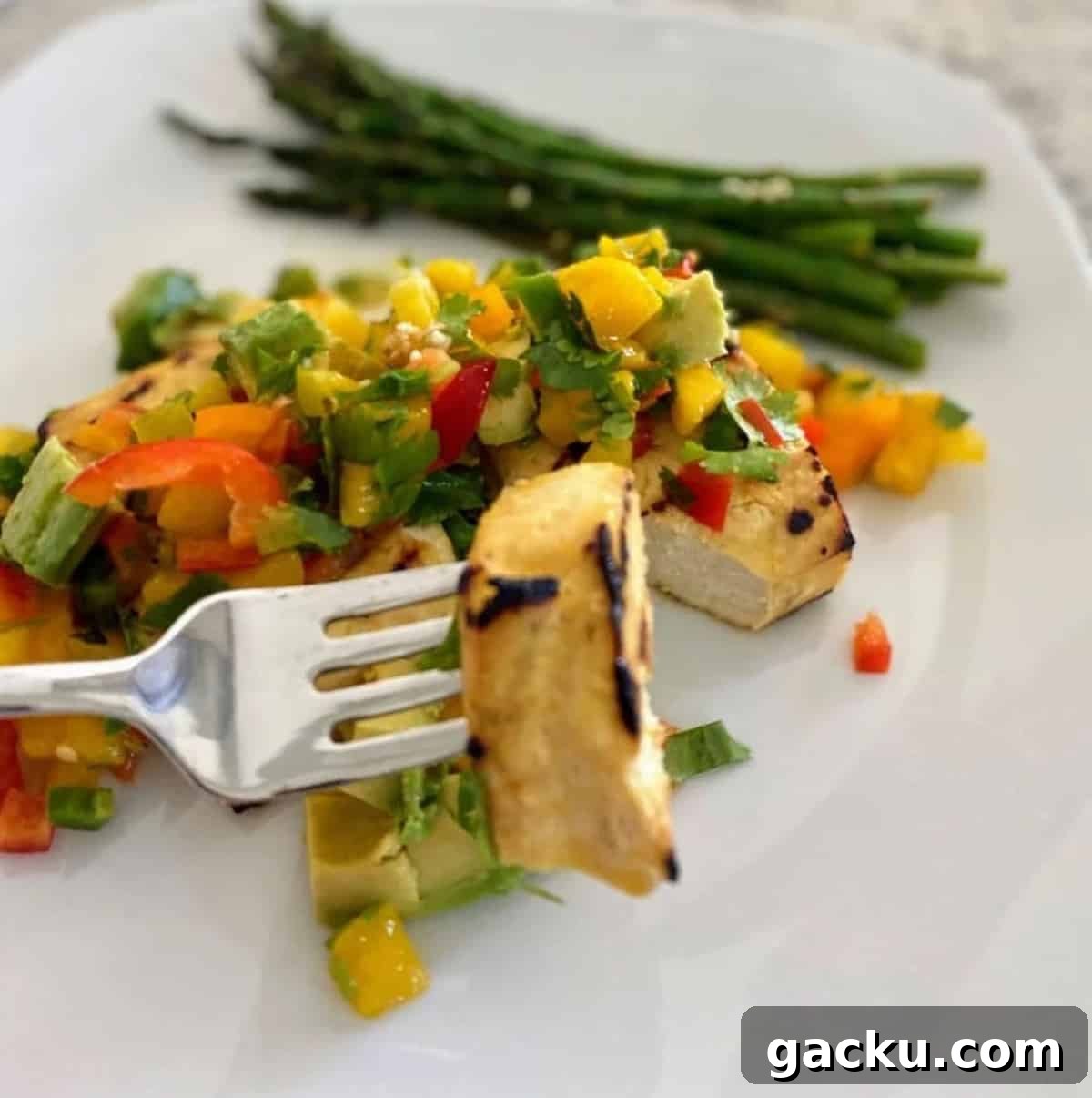 I am eating grilled tofu with mango salsa and asparagus on the side. 